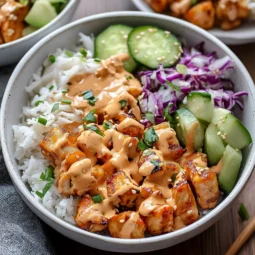 Creamy Bang Bang Chicken Bowl with grilled chicken, cucumber, cabbage, and rice for a natural Zepbound recipe